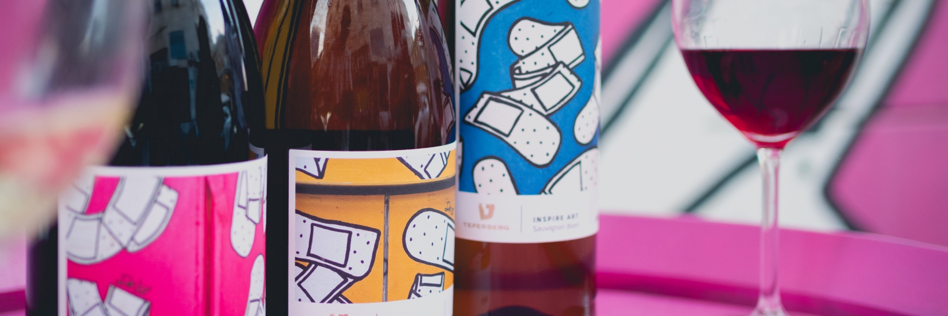 3 Inspire Art wines in from of Dede mural